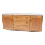 An Ercol elm sideboard, the rectangular top with a moulded edge, above three drawers flanked by two