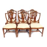 A set of six 20thC shield back dining chairs, each with a pierced and carved splat, and decorated wi