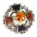 A Scottish silver brooch, of Celtic design set with orange, green and black agate, with a central ci