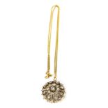 A diamond floral pendant, the raised circular pendant set with old cut diamonds, the central stone a