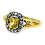 A 9ct gold Art Deco style dress ring, set with yellow sapphire surrounded by tiny diamonds, in a rub