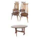 An Ercol dark elm drop leaf dining table, with circular top, 71cm high, the top 126cm diameter, toge