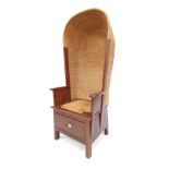 A 20thC Orkney oak framed chair, with a hooded rush back, scroll arms, on a rush seat, with drawer t