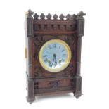 A Victorian oak cased mantel clock, bearing Roman numerals, eight day movement, a case of Gothic des