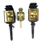 Two 19thC coach lamps, each with a black casing, 53cm high and a later metal cased lamp, 30cm high.