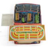 An O-gauge tin plate train set, boxed, together with a Grand National Steeple Chase Great Race Game.