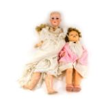 An Armand Marseille porcelain headed doll, and another. (2) We have instructions from the vendor to