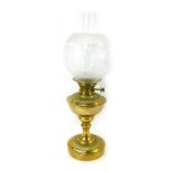 A late 19th/early 20thC brass oil lamp, with a frosted and clear glass shade, brass central reservoi