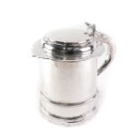 A Queen Anne silver lidded tankard, the hinged lid, shell cast thumb piece, the scroll handle with t