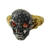 A skull dress ring, set with rubies and diamonds, in white gold, on a yellow metal band, unmarked te
