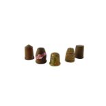 Five wooden thimbles, comprising one painted in gilt decoration with flowers, turned examples, etc.