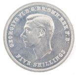 A George VI five shilling coin, dated 1951.