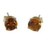 A pair of 9ct gold and citrine stud earrings, 0.7g all in, boxed.