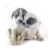 A Royal Copenhagen figure group of two dogs, 14cm high.
