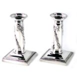 A pair of Mappin & Webb silver plated neoclassical design dwarf candlesticks, each with neoclassical