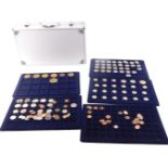 An aluminium coin case, enclosing a collection of modern collectors coins, to include pound coins an