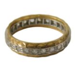 An 18ct gold diamond set eternity ring, the central band in white gold with faceted outer yellow met