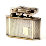 An Elisorn lighter, with white metal casing stamped silver, 3cm high.