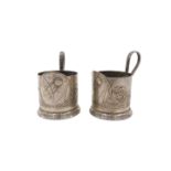 A pair of early 20thC pewter WMF style continental cup holders, each with a central crest bearing me