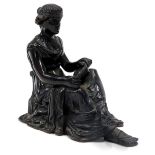 A 19thC French bronze figure of a seated lady with a book, lacking base, 14cm high.