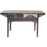 A Chinese altar table, the rectangular top above an elaborately carved frieze with two drawers, each