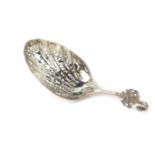 A Dutch white metal sifter spoon, with arched hook top and applied crest, on a pierced floral bowl,