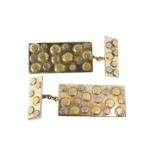 A pair of 18ct gold cuff links, each with rectangular bar set with white and yellow gold circles, wi