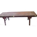A Chinese red stained opium or coffee table, with a rectangular top on cylindrical supports with str