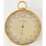 A brass cased travel barometer, with a silvered dial, 6.5cm diameter.