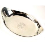 An Elizabeth II Garrard & Co silver pin dish, of oval form, with central crest depicting lions and o