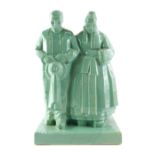 A 20thC French Quimper celadon glazed figure, of lady and gentleman, by Emile Bachelet for The