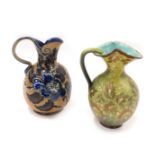 Two Doulton Lambeth stoneware jugs, each heavily decorated, one in the green and gilt floral decorat