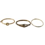 Three 9ct gold bangles, each of hammered or cross over design, 22.7g all in. (AF)