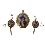 A late 19thC portrait pendant and earring set, the oval transfer printed portrait of child with lamb