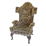 An unusual wingback armchair in mid 18thC style, upholstered in gold and black fabric, decorated wit