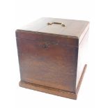 A 19thC oak square cellarette, the hinged lid with a brass handle, on a plinth, 35cm high, 33cm wide