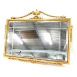 A gilt rectangular wall mirror in Adam style, the crest applied with urn and bell flower swags, the