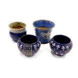 Four Royal Doulton stoneware bowls, comprising a pair of Doulton royal blue glazed fleur-de-lys and
