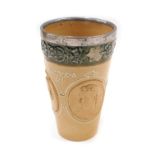 A Doulton Lambeth stoneware goblet, with a green thistle border and a silver collar with Queen Victo