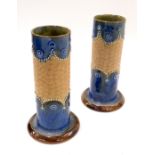 A pair of Royal Doulton stoneware vases, each turreted form with blue and brown glazing, on a conica