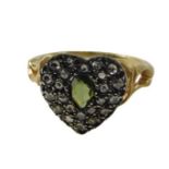 A heart shaped dress ring, pave set with diamonds and central peridot, with scroll shoulders, yellow