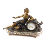 A late 19thC French bronzed spelter figural mantel clock, model in the form of a reclining lady with