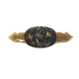 A Victorian bar brooch, the oval panel on black slate, with raised relief, swallows and flowers, in