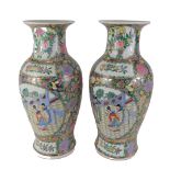 A pair of modern Chinese vases, each with famille verte design and figures, 46cm high.