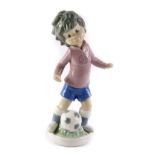 A Lladro Sport Billy Productions figure, of a child footballer, 22cm high.