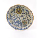 A 20thC Chinese stand or tray, with a fluted a petalated border, with hand painted blue and yellow d