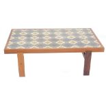 A large Danish rosewood coffee table, the rectangular top inset with ceramic tiles on plain supports