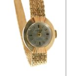 A Manis 9ct cased ladies wristwatch, with a small silvered dial on bark effect bracelet, with fan ri