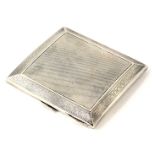 A George V silver cigarette case, with engine turned decoration and Greek key border, bearing inscri