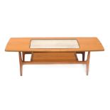 A Schreiber Aeroplane teak coffee table, of tapering form with shaped ends, glass insert and lower s